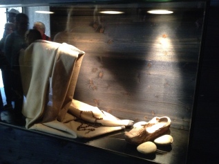 St Bernadette's family became very poor in her adolescence. Their home was incredibly poor - unfit to even be a prison. These are the only belongings that she had I believe. a cloak, some clogs and her rosary.